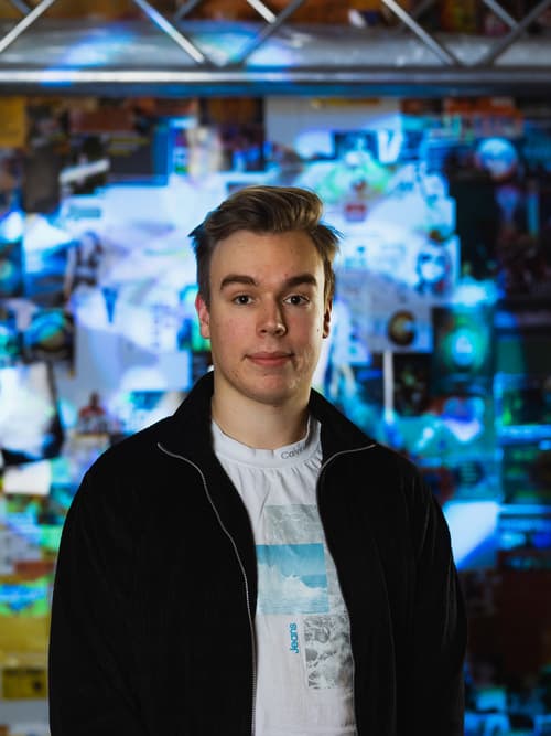 Portrait of Mikko Rajakorpi in front of colorful background